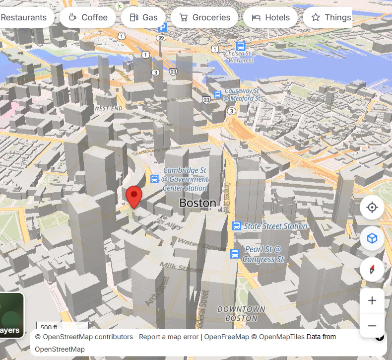 Downtown Boston tilted and turned, with buildings drawn in 3D; the tilt button and the compass are highlighted at the right edge of the map